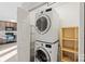 Convenient laundry room featuring a stacked washer and dryer, and a view into the kitchen at 2505 Ashford Dr, Newton, NC 28658