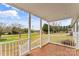 Covered porch with brick flooring and white railing at 4264 C & B Farm Rd, Conover, NC 28613