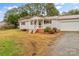 Front view of charming ranch home with a gravel driveway at 4264 C & B Farm Rd, Conover, NC 28613