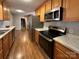 Modern kitchen with stainless steel appliances and wood cabinets at 4264 C & B Farm Rd, Conover, NC 28613