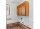 Laundry room with overhead cabinets and brick wainscoting at 4264 C & B Farm Rd, Conover, NC 28613