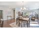 Bright dining area with hardwood floors and modern chandelier at 4779 Looking Glass Trl, Denver, NC 28037