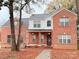 Brick two-story house with a covered porch and landscaping at 5846 Hanna Ct, Charlotte, NC 28212