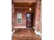 Brick front porch with a glass entry door and sidelights at 5846 Hanna Ct, Charlotte, NC 28212