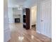 Hardwood floor living room with a fireplace and powder room at 5846 Hanna Ct, Charlotte, NC 28212