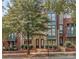 Attractive brick townhome with two-story design, arched entry, and landscaping at 658 E 10Th St, Charlotte, NC 28202