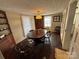 Dining room with chandelier, natural lighting, and dark wood flooring at 105 Beaver St, China Grove, NC 28023