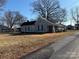 Charming single Gathering home featuring a covered front porch and a well-maintained yard and established trees in the front at 105 Beaver St, China Grove, NC 28023