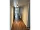 Hallway featuring hardwood floors, neutral walls, access to rooms, with access to the front door at the end at 105 Beaver St, China Grove, NC 28023