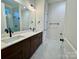 Double vanity bathroom with dark brown cabinets and marble floors at 166 Fulworth Nw Dr # 67, Concord, NC 28027