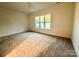 Spacious bedroom with neutral carpeting and large window at 166 Fulworth Nw Dr # 67, Concord, NC 28027