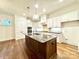 Modern kitchen with white cabinets, large island, and hardwood floors at 166 Fulworth Nw Dr # 67, Concord, NC 28027