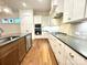 Modern kitchen with white cabinets, dark countertops, and stainless steel appliances at 166 Fulworth Nw Dr # 67, Concord, NC 28027