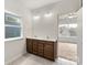 Bright bathroom with a double vanity, sleek fixtures, and tile flooring at 18024 Wilbanks Dr, Charlotte, NC 28278