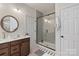 Bathroom featuring a glass-enclosed shower, modern vanity, and a neutral color palette at 18024 Wilbanks Dr, Charlotte, NC 28278