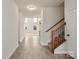 Inviting hallway with tile flooring and a staircase leading to the upper level, showing seamless flow at 18024 Wilbanks Dr, Charlotte, NC 28278