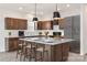 Modern kitchen with stainless steel appliances, a large island with seating, and ample cabinet space at 18024 Wilbanks Dr, Charlotte, NC 28278