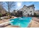 Inviting backyard with a refreshing blue pool, diving board, and spacious patio area at 1811 Robbins Meadows Dr, Waxhaw, NC 28173