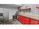 Basement kitchenette with red cabinets and concrete countertop at 1811 Robbins Meadows Dr, Waxhaw, NC 28173