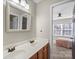 Bathroom with double vanity and a view into a bedroom at 1811 Robbins Meadows Dr, Waxhaw, NC 28173