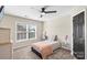 Simple bedroom with window, ceiling fan, and closet at 1811 Robbins Meadows Dr, Waxhaw, NC 28173