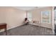 Bright bedroom with neutral walls, carpeting, and two windows at 1811 Robbins Meadows Dr, Waxhaw, NC 28173