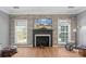 Living room with a modern fireplace and stone wall at 1811 Robbins Meadows Dr, Waxhaw, NC 28173