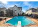 Relaxing pool area with diving board, lounge chairs, and a large deck at 1811 Robbins Meadows Dr, Waxhaw, NC 28173