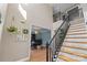 Stylish staircase with black railing and stone accent wall at 1811 Robbins Meadows Dr, Waxhaw, NC 28173