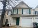 Charming townhome featuring a one-car garage, green shutters, and a welcoming front entrance at 5334 Esther Ln, Charlotte, NC 28214