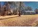 Sprawling backyard with mature trees and a single-story home with a detached garage at 588 Blossom Hill Rd, Lincolnton, NC 28092