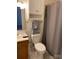 Cozy bathroom includes a white toilet, updated cabinet, and shower with curtain at 588 Blossom Hill Rd, Lincolnton, NC 28092