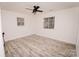 Bright bedroom features updated floors, a modern ceiling fan, and two windows at 588 Blossom Hill Rd, Lincolnton, NC 28092