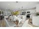 Open concept kitchen and dining area with white cabinetry and stainless steel appliances at 607 King Arthur Dr, Gastonia, NC 28056