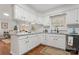 White kitchen cabinets, granite countertops, and hardwood floors at 610 Crescent Cir, Kings Mountain, NC 28086