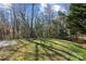 Spacious backyard featuring beautiful trees with a grassy area at 6707 Brachnell View Dr, Charlotte, NC 28269