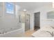 Bright bathroom showcasing a bathtub and separate glass-enclosed shower at 6707 Brachnell View Dr, Charlotte, NC 28269