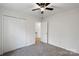 Bedroom featuring carpet flooring, closet, and a view of the staircase at 6707 Brachnell View Dr, Charlotte, NC 28269