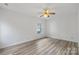 Bedroom featuring a ceiling fan and new floors, and window with natural light at 6707 Brachnell View Dr, Charlotte, NC 28269