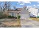 Charming home with dormer windows, manicured bushes and a two-car garage at 6707 Brachnell View Dr, Charlotte, NC 28269