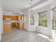 A kitchen nook features bright lighting with ample windows and wood cabinets at 6707 Brachnell View Dr, Charlotte, NC 28269