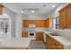 Kitchen view with bright lighting, wooden cabinets, and white appliances at 6707 Brachnell View Dr, Charlotte, NC 28269