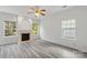 Spacious living room with a fireplace and hardwood floors and ample windows at 6707 Brachnell View Dr, Charlotte, NC 28269