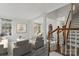 Bright, open-concept living room featuring neutral decor and a staircase with wooden banister at 6707 Brachnell View Dr, Charlotte, NC 28269