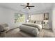 Serene main bedroom with a tray ceiling, large window, and elegant neutral color scheme at 6707 Brachnell View Dr, Charlotte, NC 28269