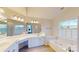 Elegant bathroom with double vanity, jetted tub, and window at 7031 Walton Heath Ln, Charlotte, NC 28277