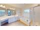 Bathroom features a double vanity, soaking tub, and shower at 7031 Walton Heath Ln, Charlotte, NC 28277