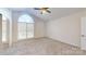 Bedroom with arched window and ceiling fan at 7031 Walton Heath Ln, Charlotte, NC 28277