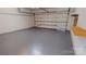 Attached garage with epoxy floor and storage shelf at 7031 Walton Heath Ln, Charlotte, NC 28277