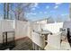 Charming backyard patio with a dining table and four chairs, surrounded by a white fence for privacy at 7122 Abbotts Glen Dr, Charlotte, NC 28212